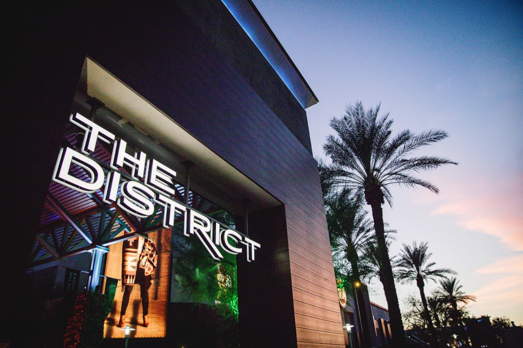 a building with a sign reading the district stands against an open sky