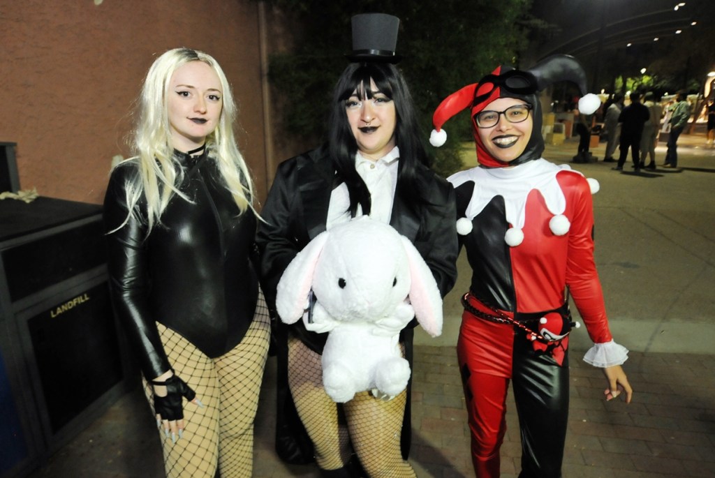 Three women dressed as DC Comics heroines.