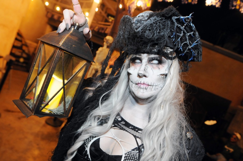 A women dressed as a ghostly white figure.