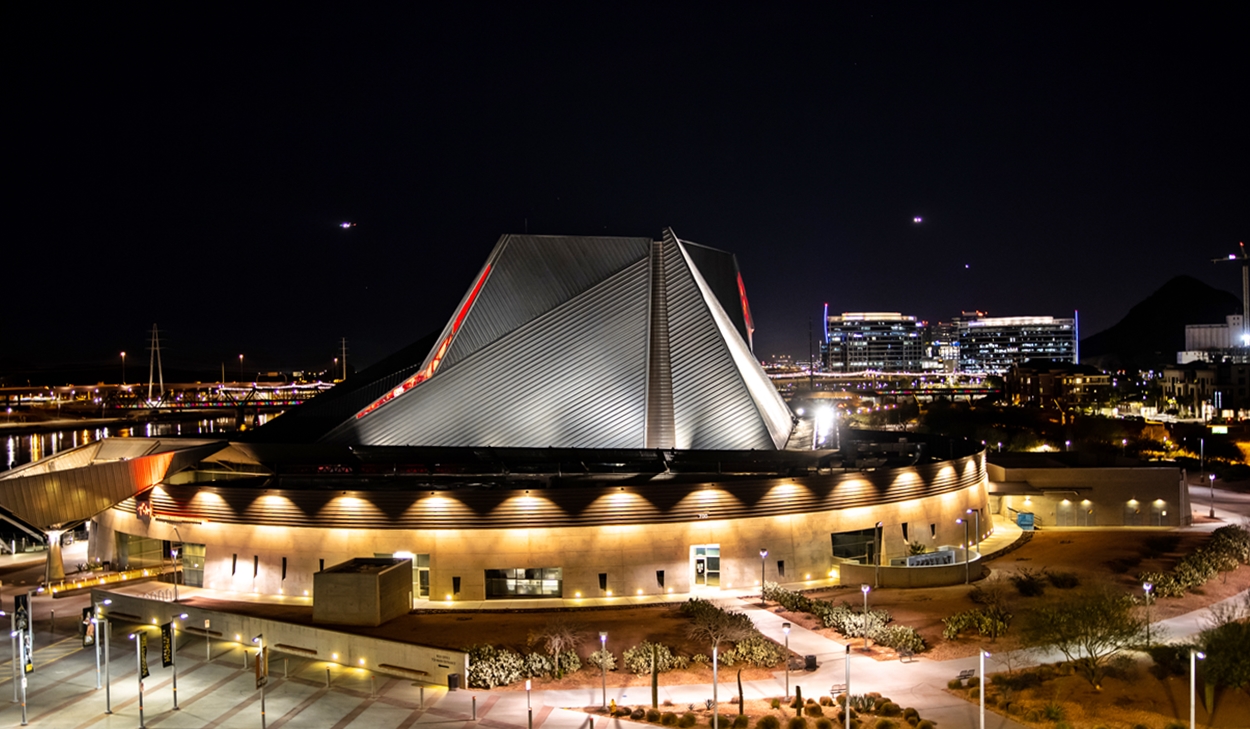 An aerial view of an enormous angular surrounded by lights.