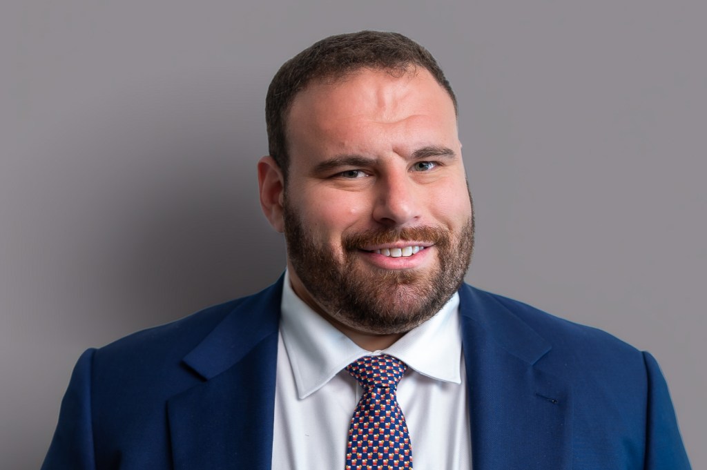 a bearded man in a blue suit