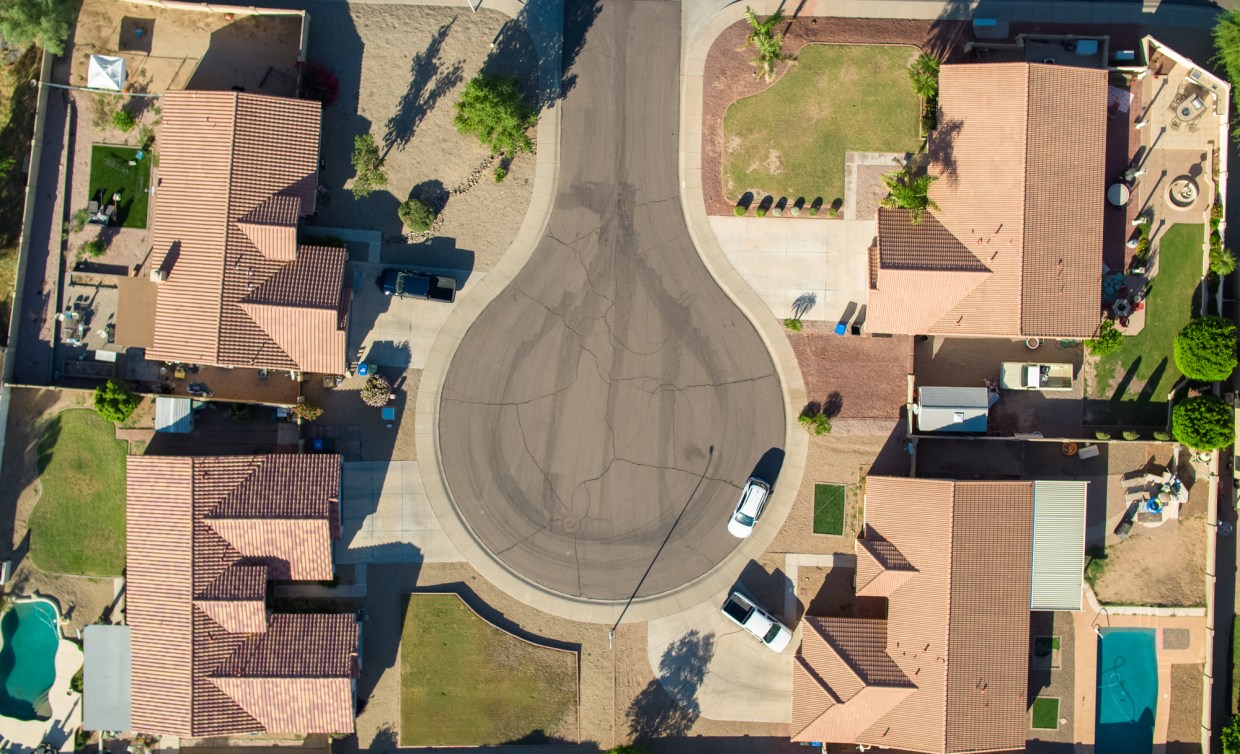 a drone shot taken above four houses on a cul-de-sac in Phoenix