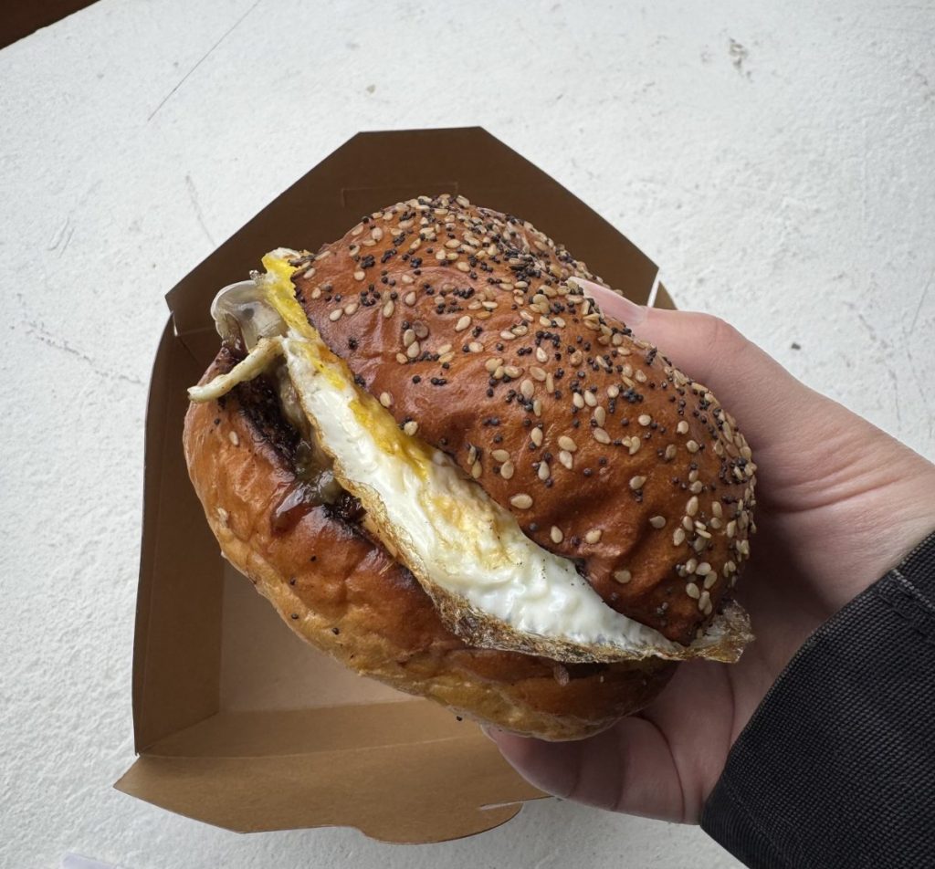 A sausage, egg and cheese sandwich on a poppy-seed roll.