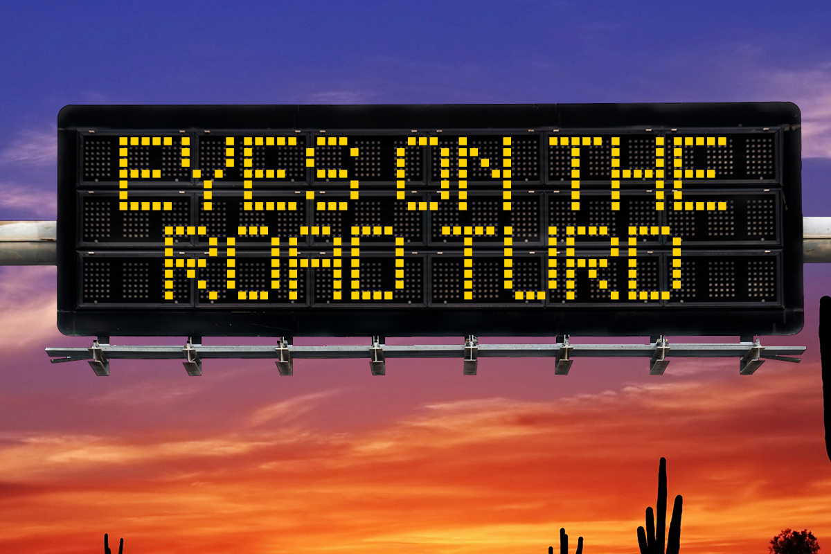 a highway safety sign that says "eyes on the road turd"
