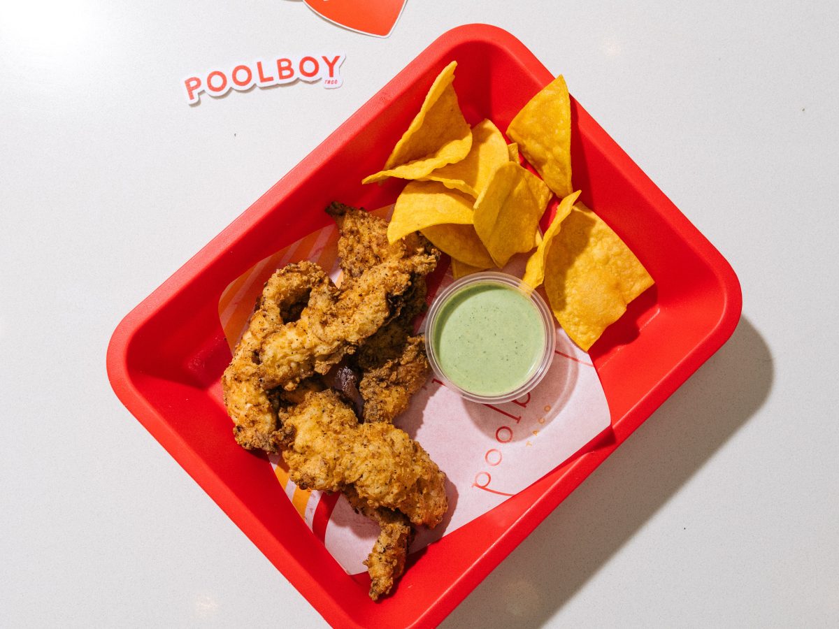 A tray with chicken tenders, chips and salsa