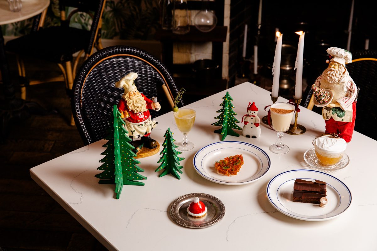 A bistro table with plates and cocktails.