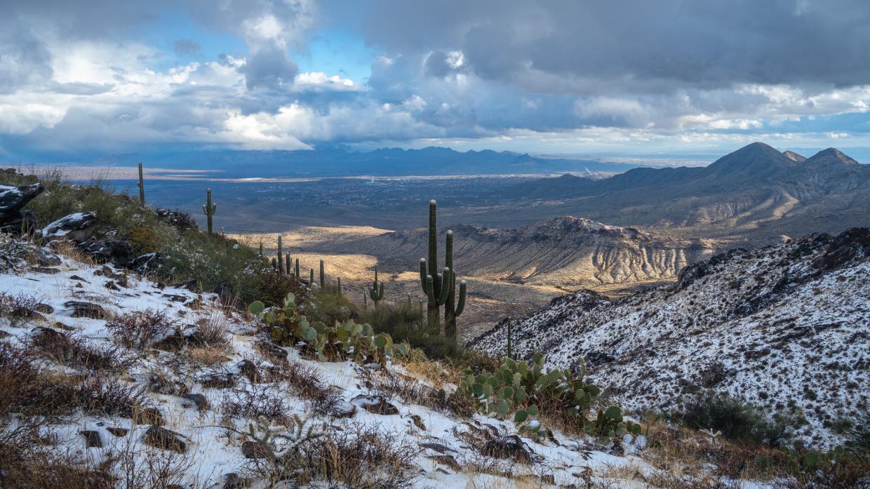 A dusting of snow during break in winter storm on Lookout Trail in the McDowell Mountains in 2024. Fountain Hills can be seen in the distance.