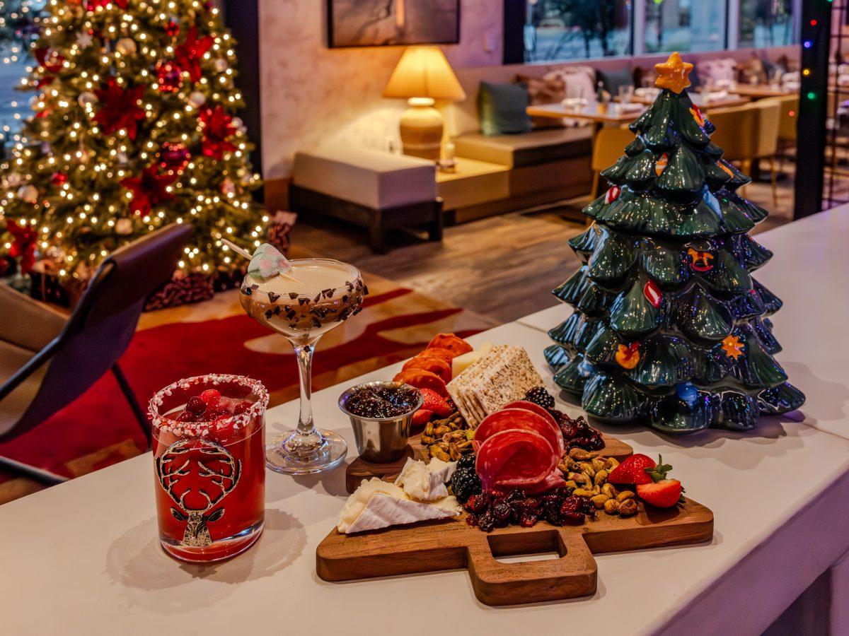 Holiday cocktails and charcuterie on a bar.