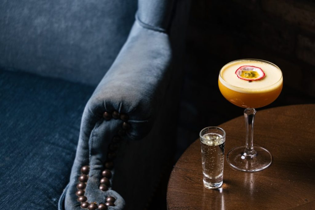 A portstar martini with a sidecar of bubbles on a table.