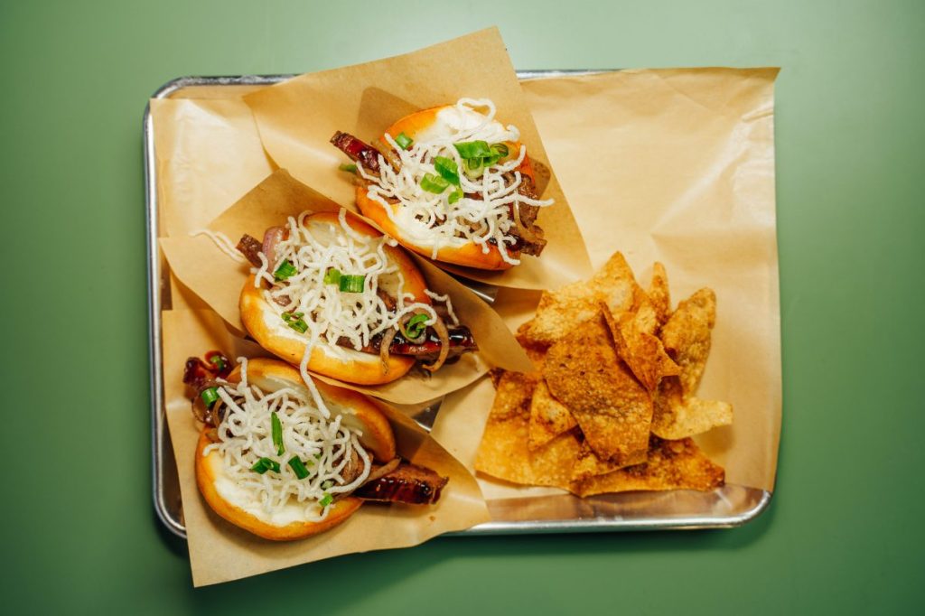 A tray of Bao buns and wonton chips.