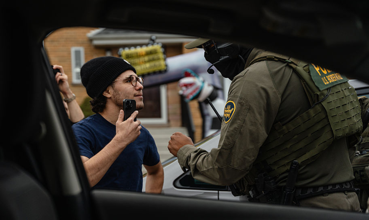 a man films a border patrol agent