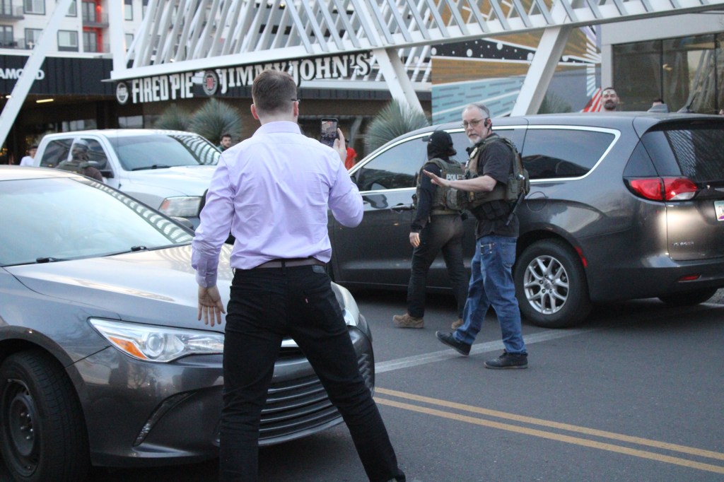 a man films an ice agent