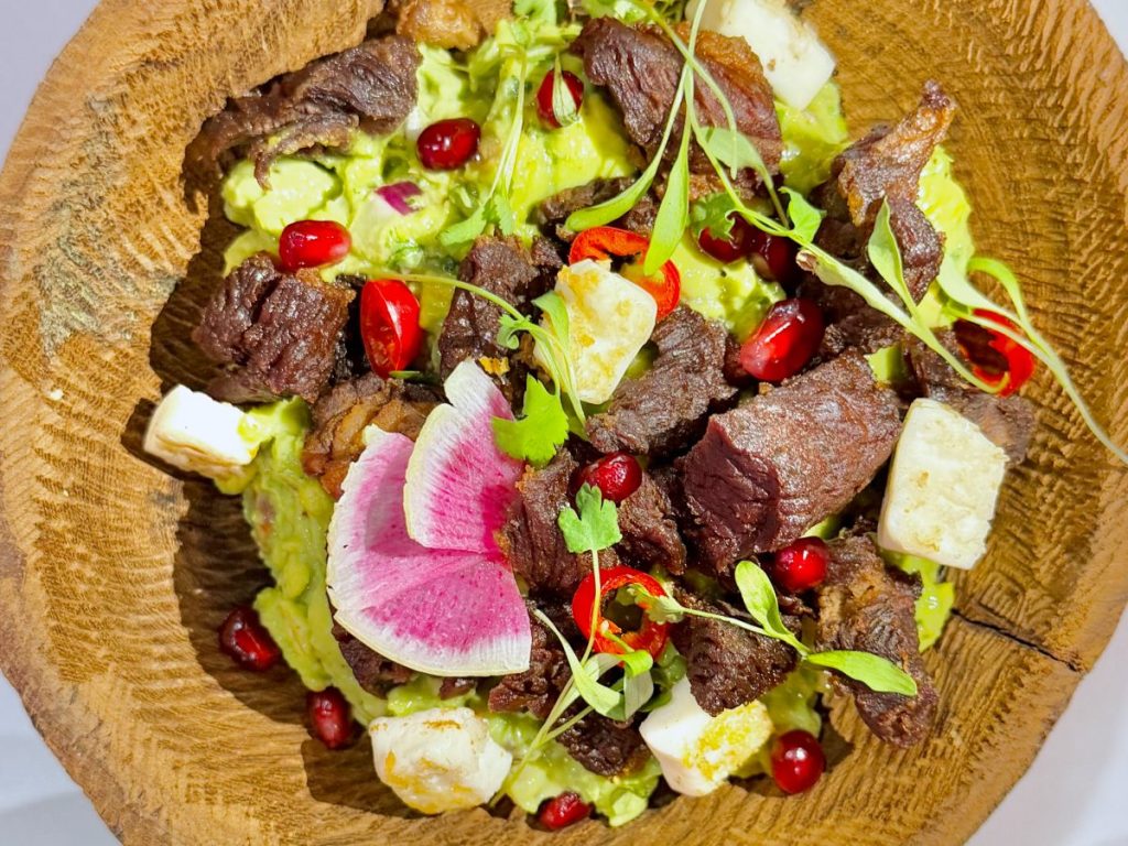 Guacamole topped with chunks of ribeye.