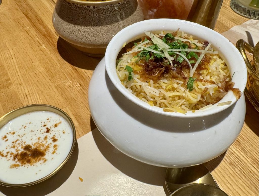 A porcelain urn filled with biryani.