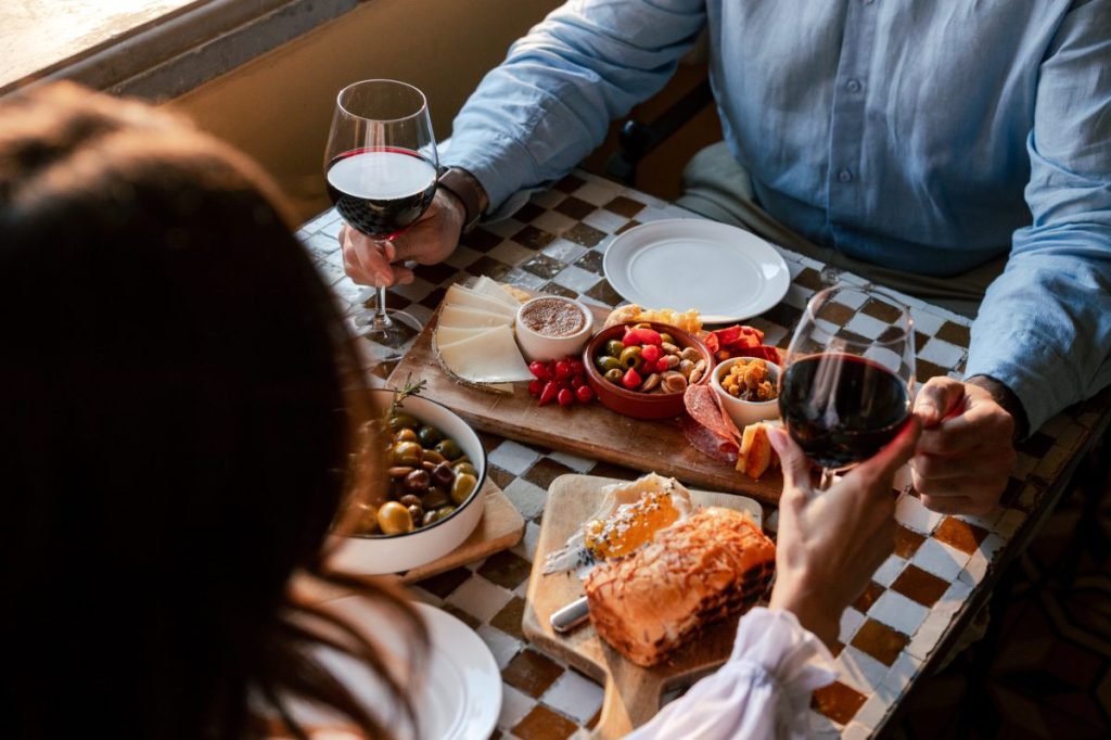 Diners at a table with wine and tapas.