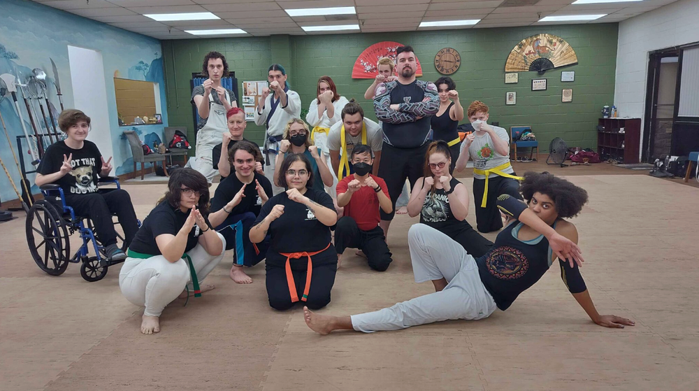 people pose in a martial arts studio