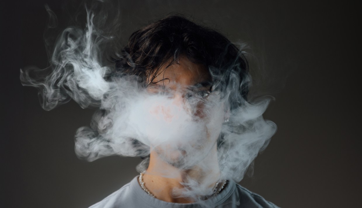 a head behind a cloud of vape smoke