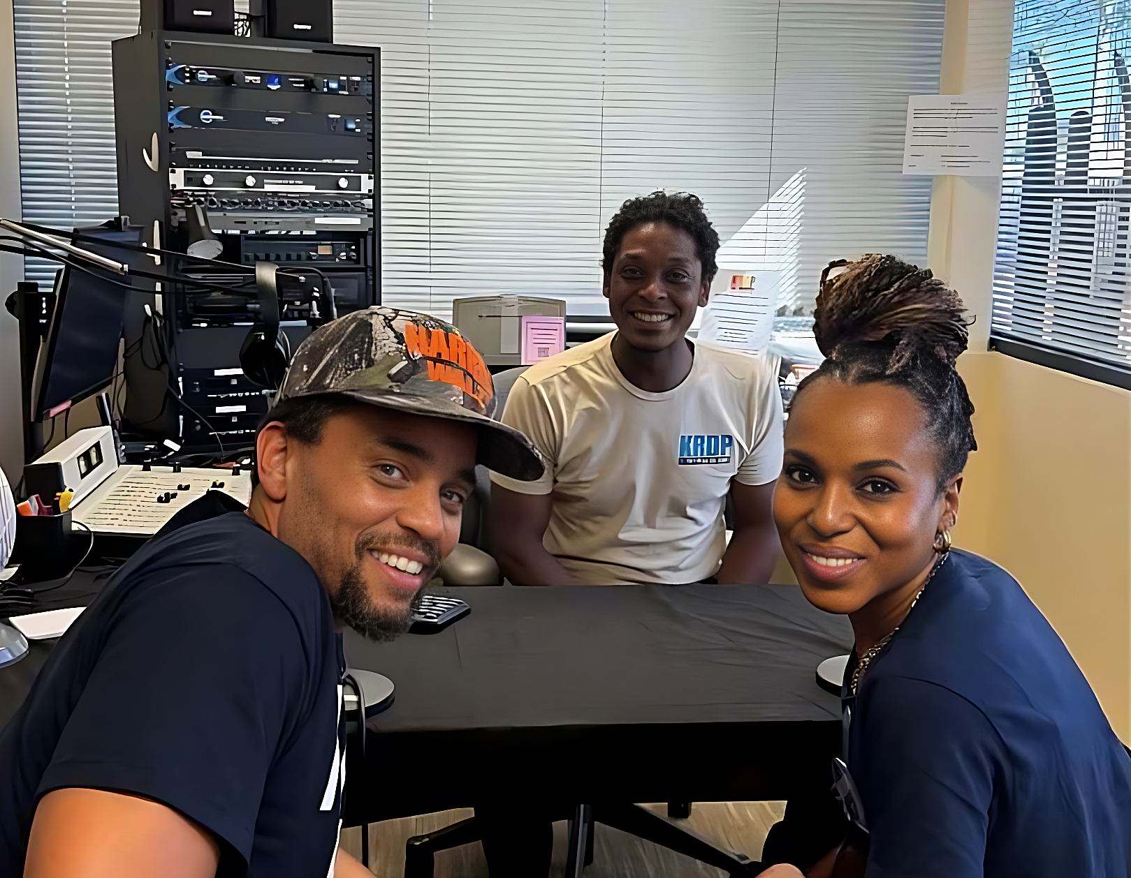 Three people inside the studio of Phoenix community radio station KRDP, which was damaged during a late December break-in.