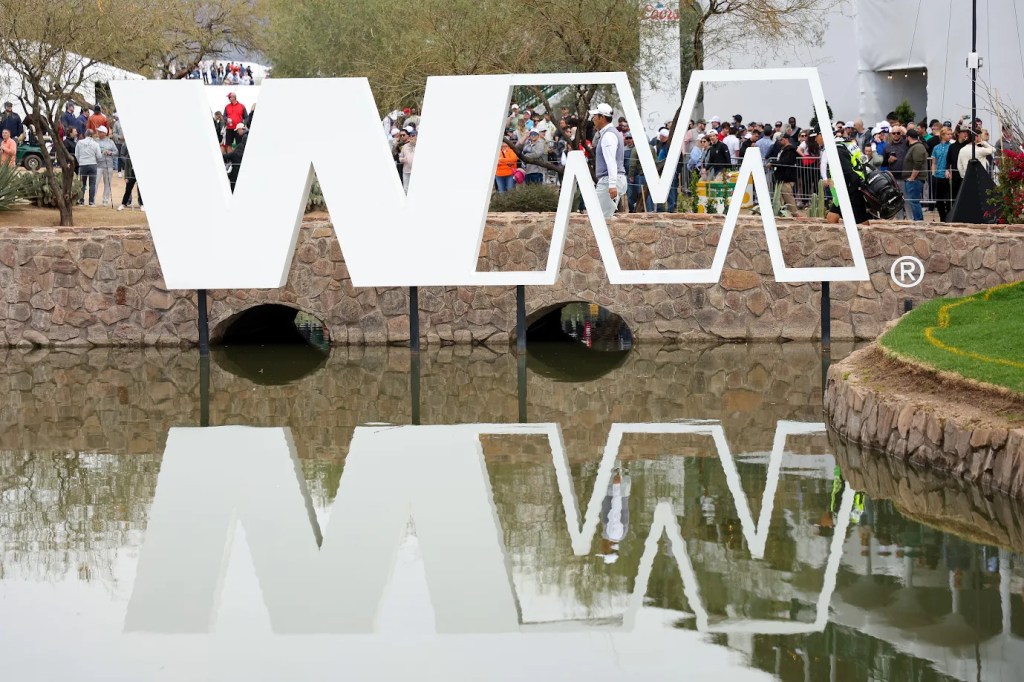 Hideki Matsuyama of Japan crosses the bridge on the 15th hole near the WM logo during the second round of the WM Phoenix Open.