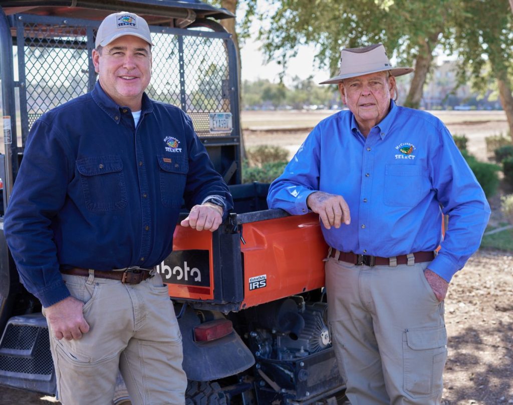 Two farmers on land.
