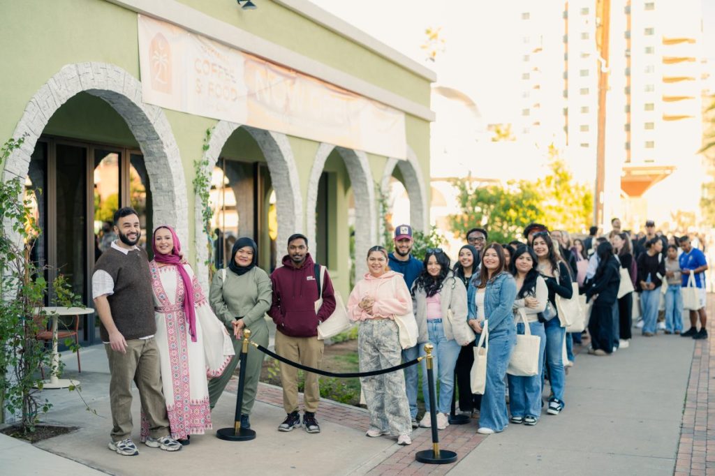 People lined up for the opening of a cafe.