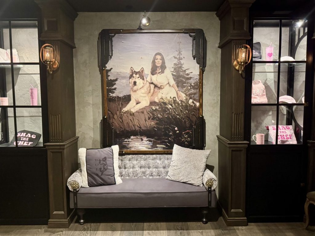 A painting of Lisa Vanderpump with a wolf hangs in a lobby next to the host stand a Wolf by Vanderpump in Scottsdale.