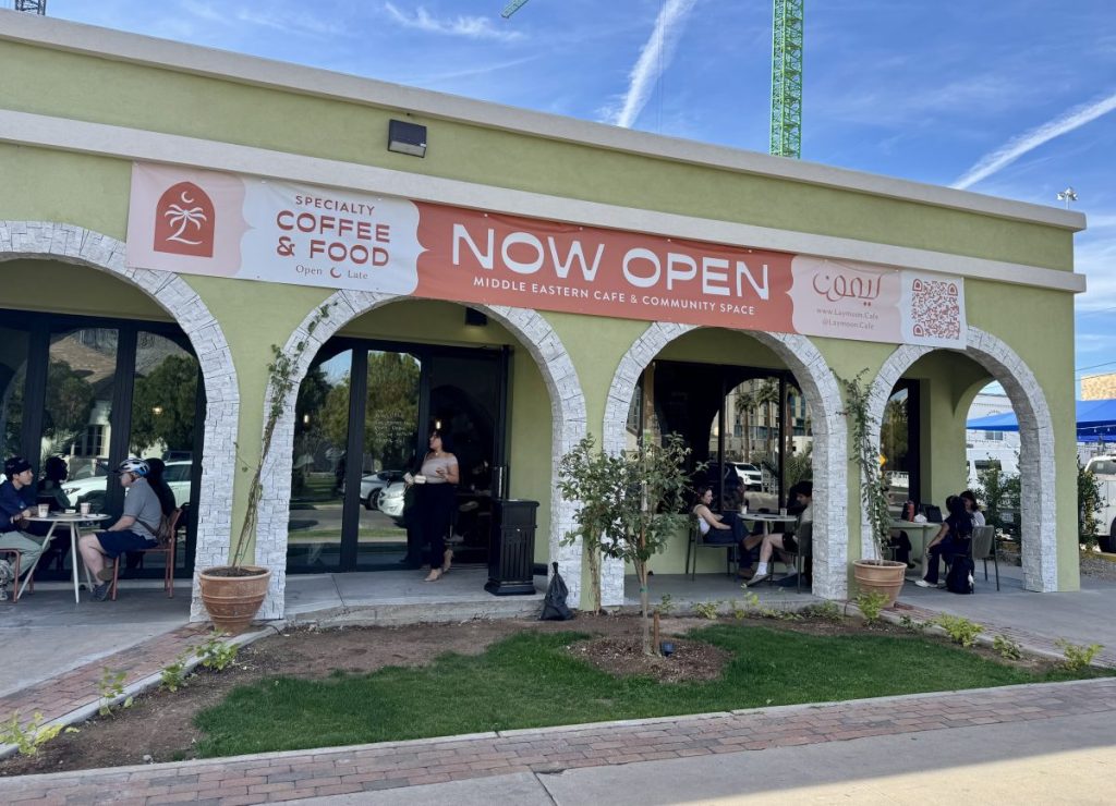 People sit on a covered patio at a cafe.