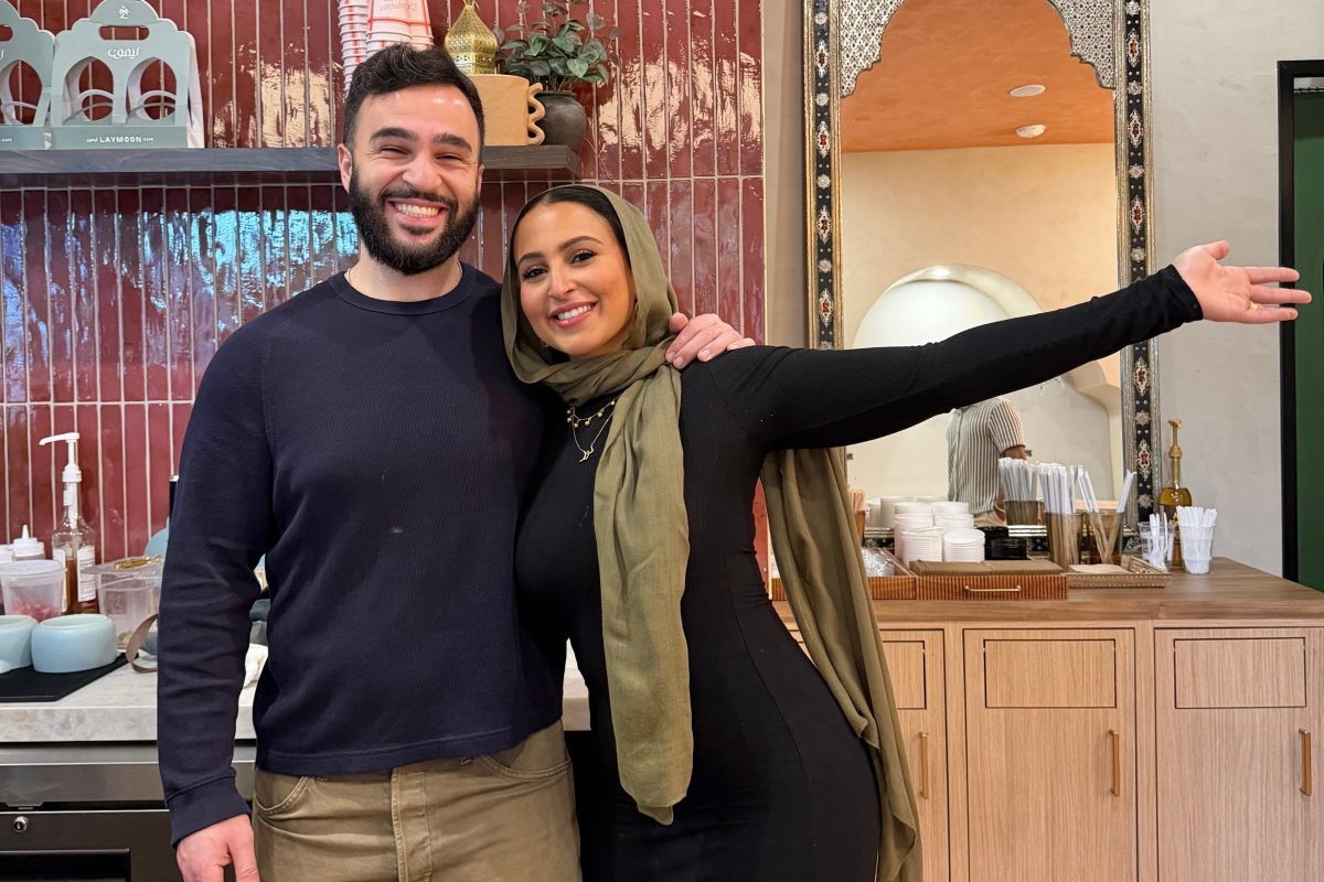 Siblings posing inside a coffee shop.