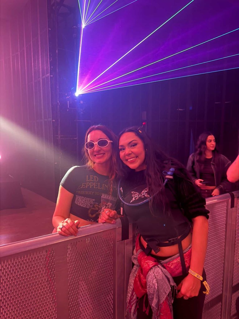 the artist Nala poses beside a smiling fan