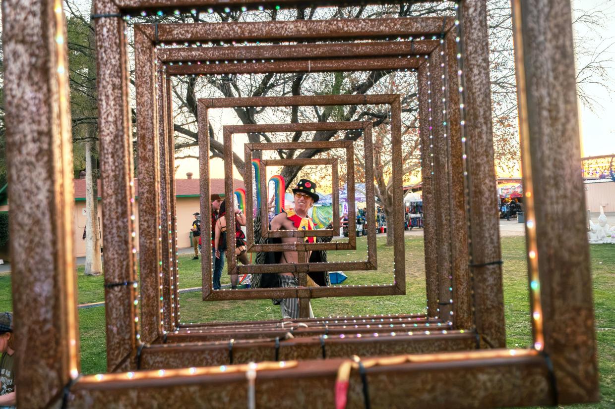 a man stands in the center of a row of frames