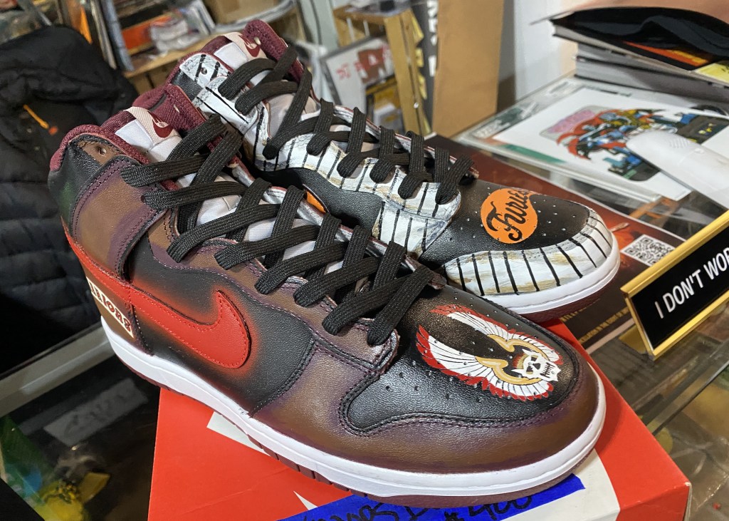 Two sneakers decorated with custom artwork inspired by the cult film "The Warriors.
