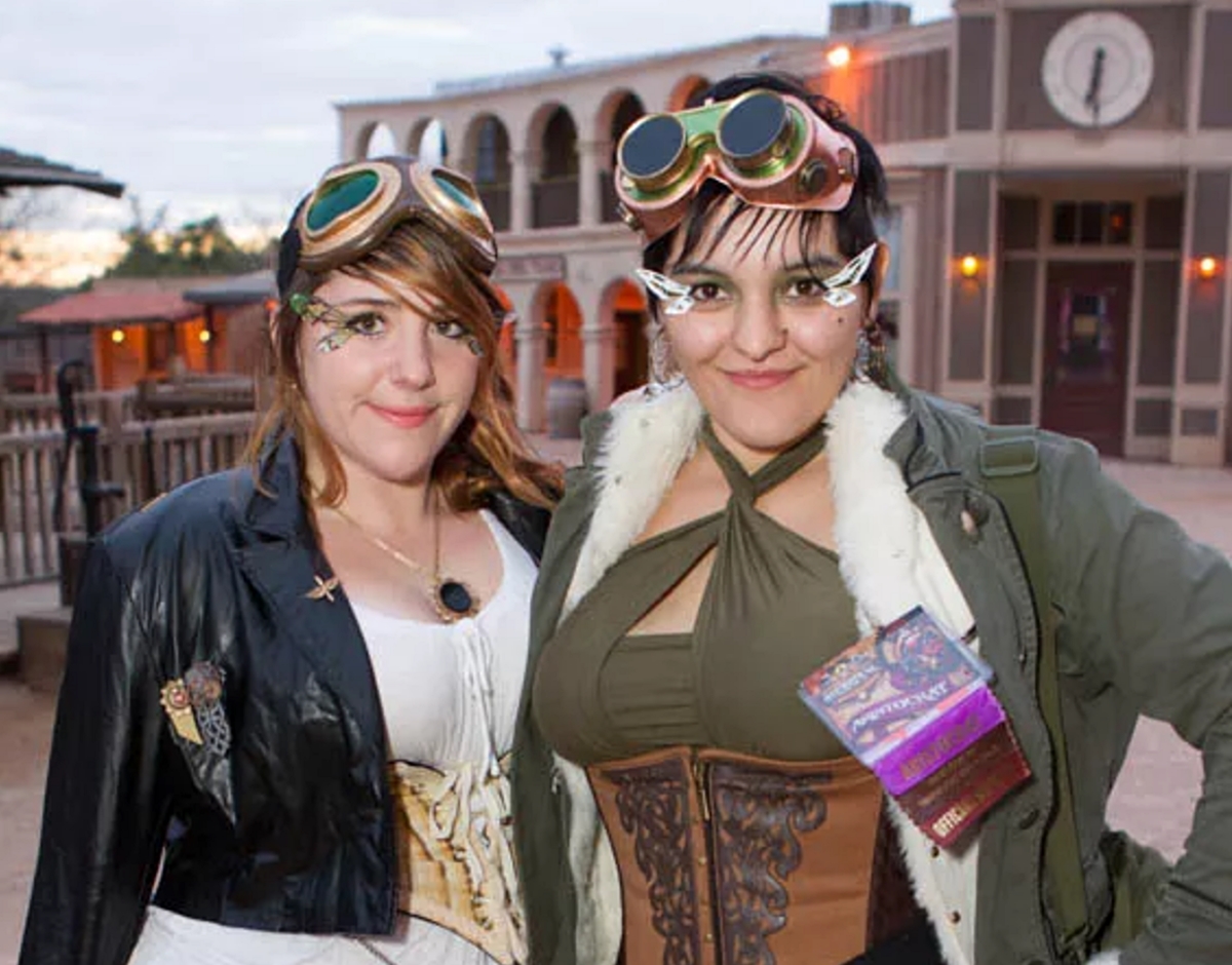 Two women dressed in steampunk costuming at a Wild West town.
