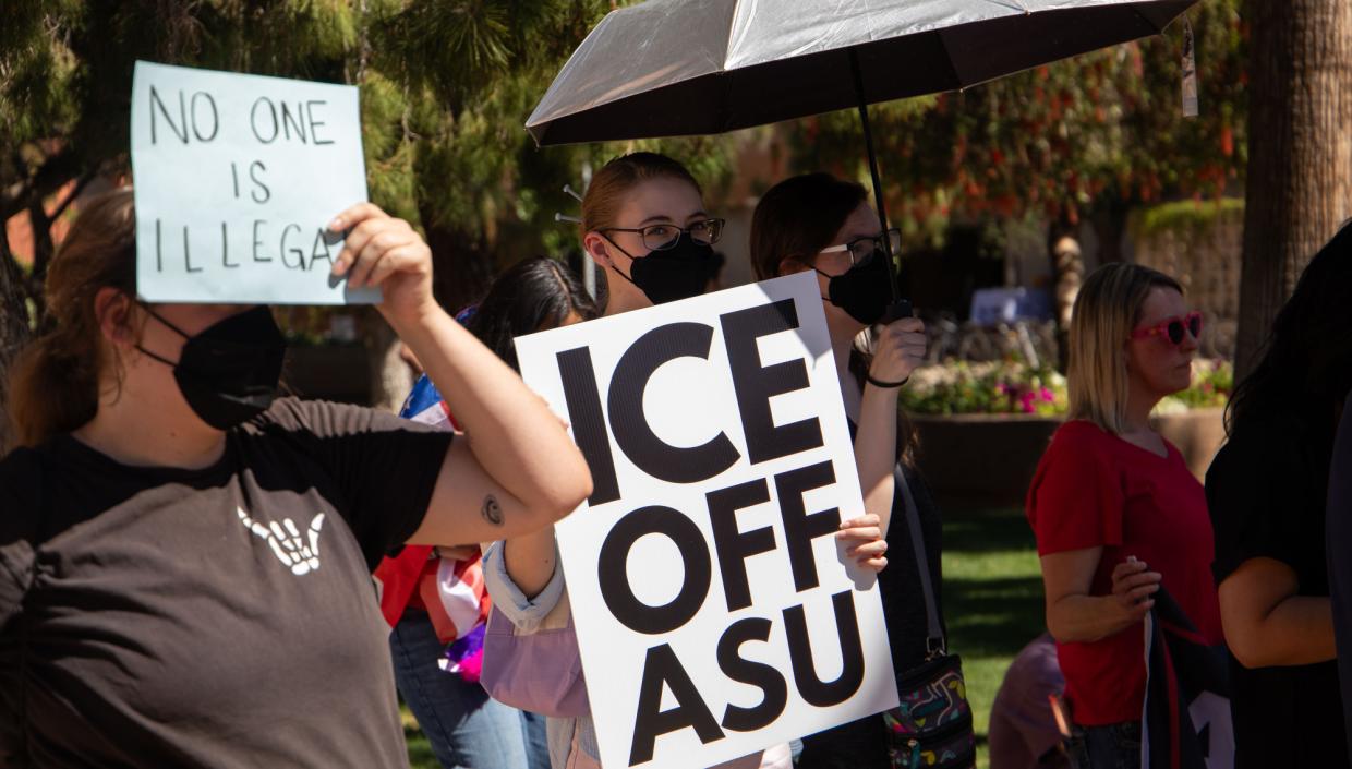 a protester holds a sign that says "ICE OFF ASU"