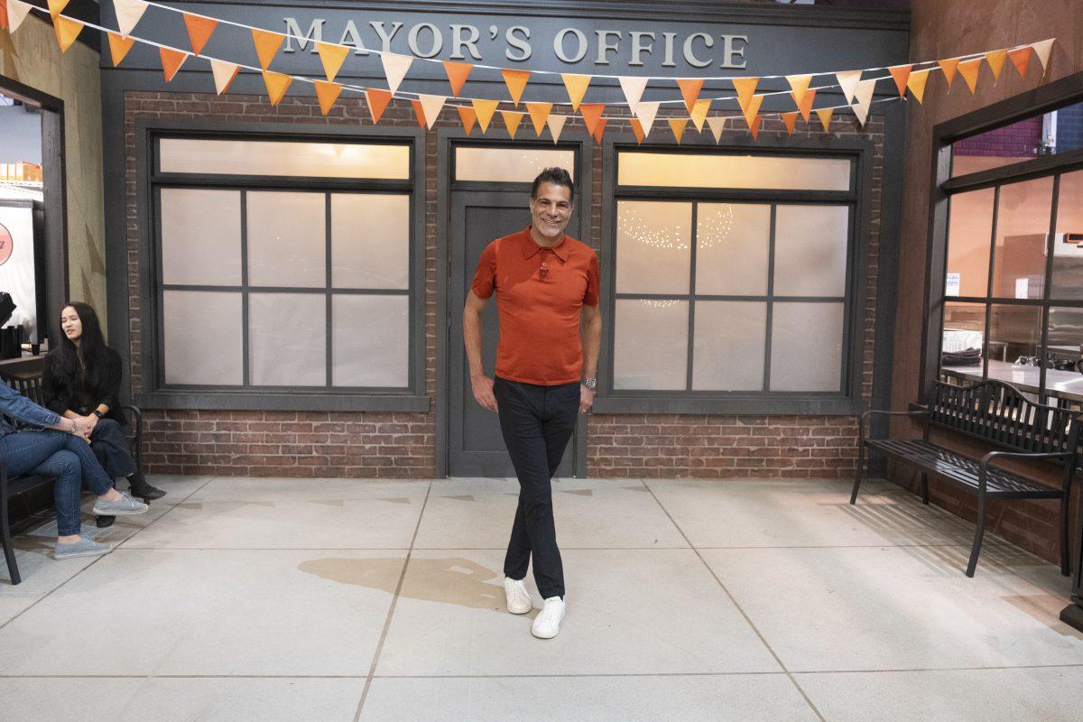 Chef Angelo Sosa poses in front of the mayor's office of Flavortown, Guy Fieri's fictional city that is the backdrop to a new Food Network cooking competition.