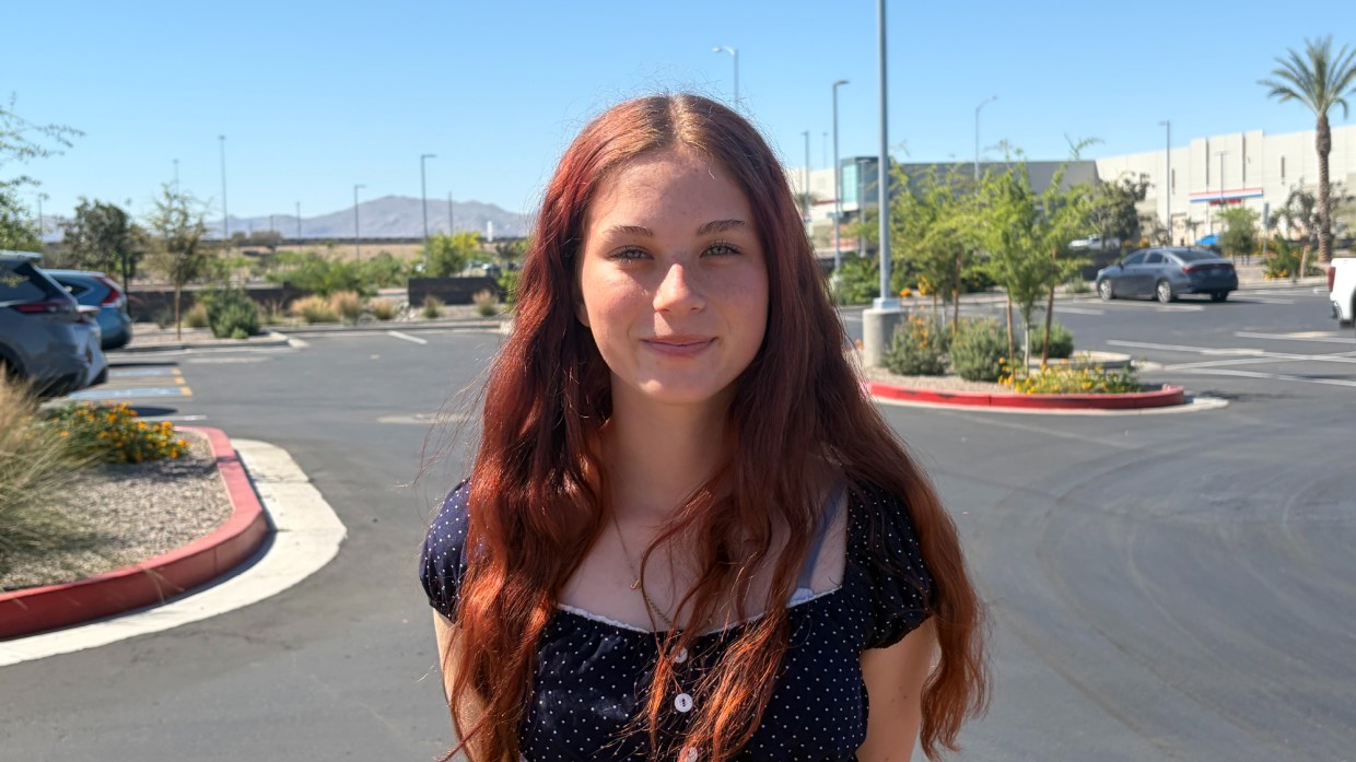 cali overs, redheaded teenage girl in a school parking lot