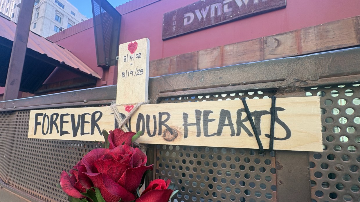 a wooden cross and roses that says "forever in our hearts" outside club dwntwn in phoenix