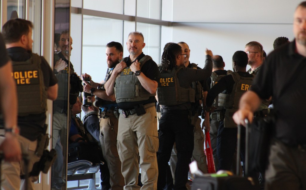 ICE agents stand around during a deployment to Phoenix Sky Harbor International Airport on March 23, 2026.