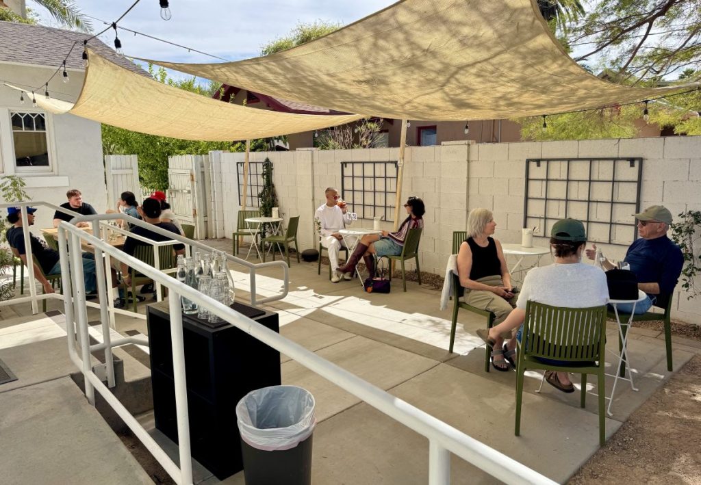 People sit around tables on the patio at Matilda's.
