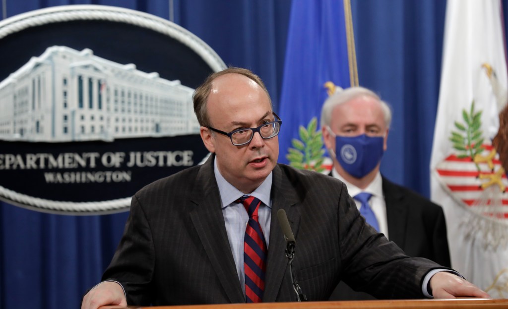 jeffrey clark speaks at a podium in front of the white house seal