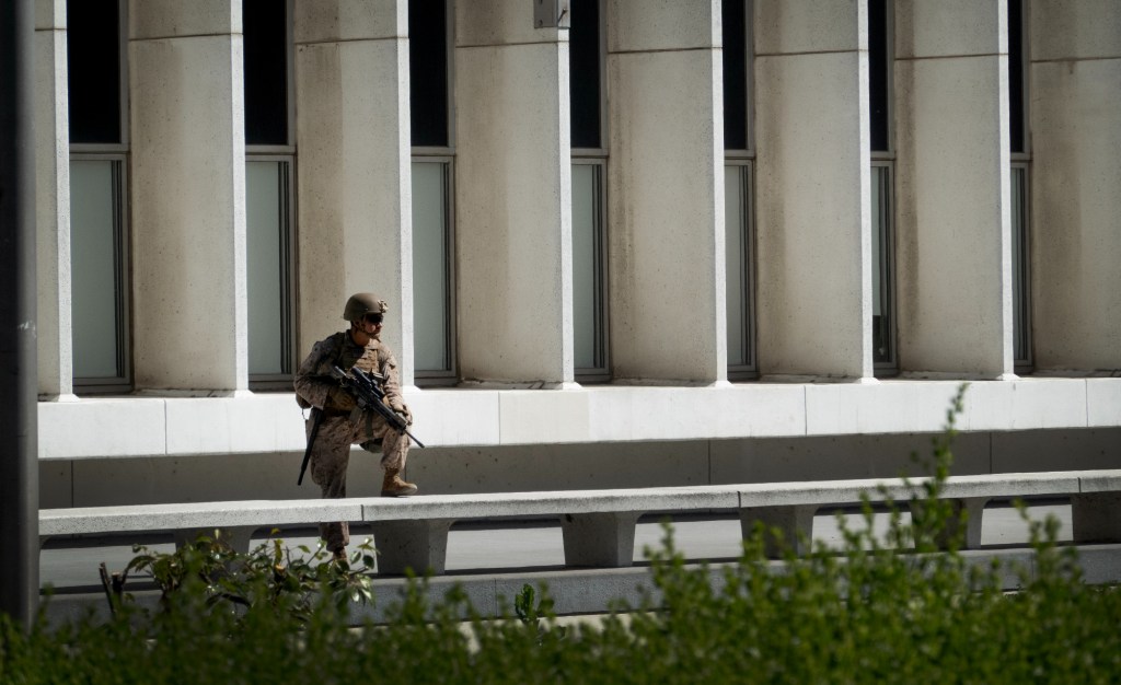 A U.S. Marine stands guard at Los Angeles' Westwood Federal Building complex as demonstrators protest U.S. involvement in the Israel/Iran conflict in front of the facility in June 2025. 