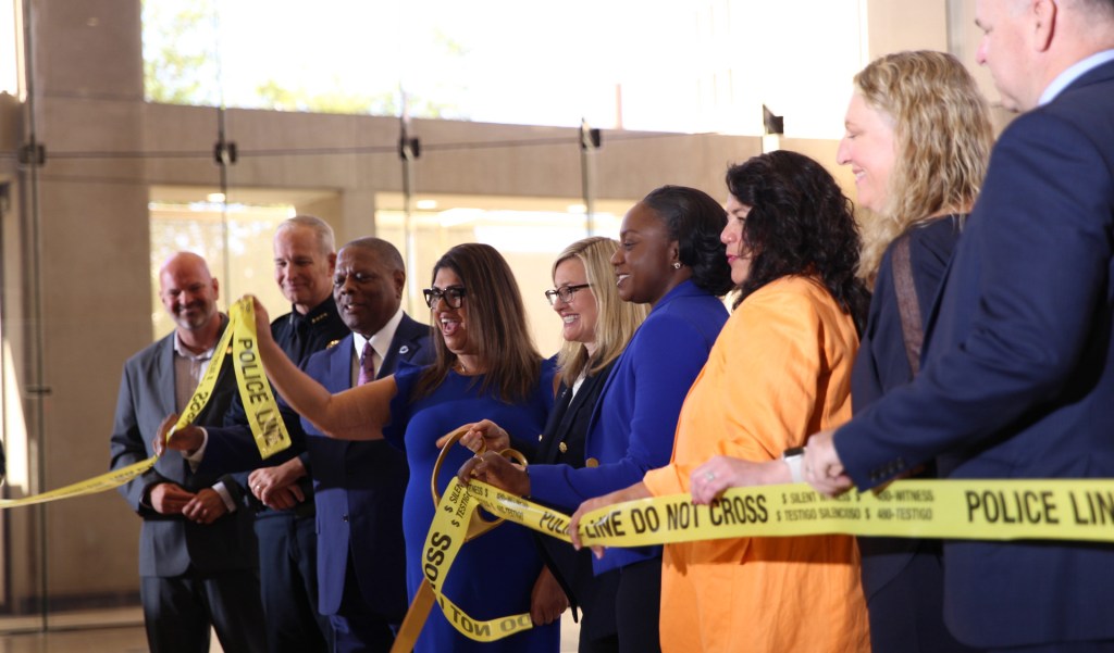 phoenix mayor kate gallego and city officials cut a yellow ribbon with ceremonial scissors
