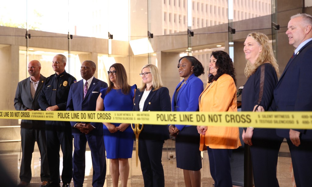 phoenix mayor kate gallego and city officials cut a yellow ribbon with ceremonial scissors