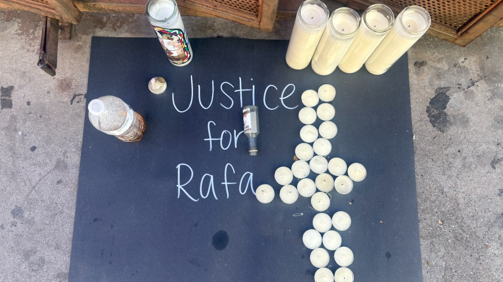 candles in the shape of a cross next to the words "justice for rafa"