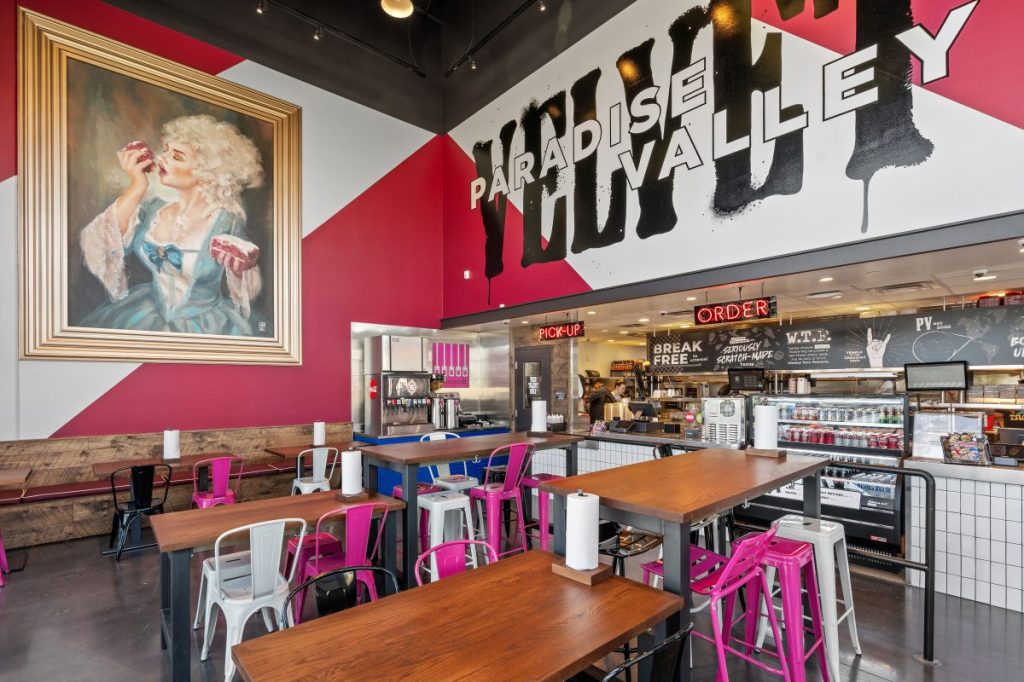 The dining room, service counter and Marie Antoinette-inspired art at Velvet Taco in Phoenix.
