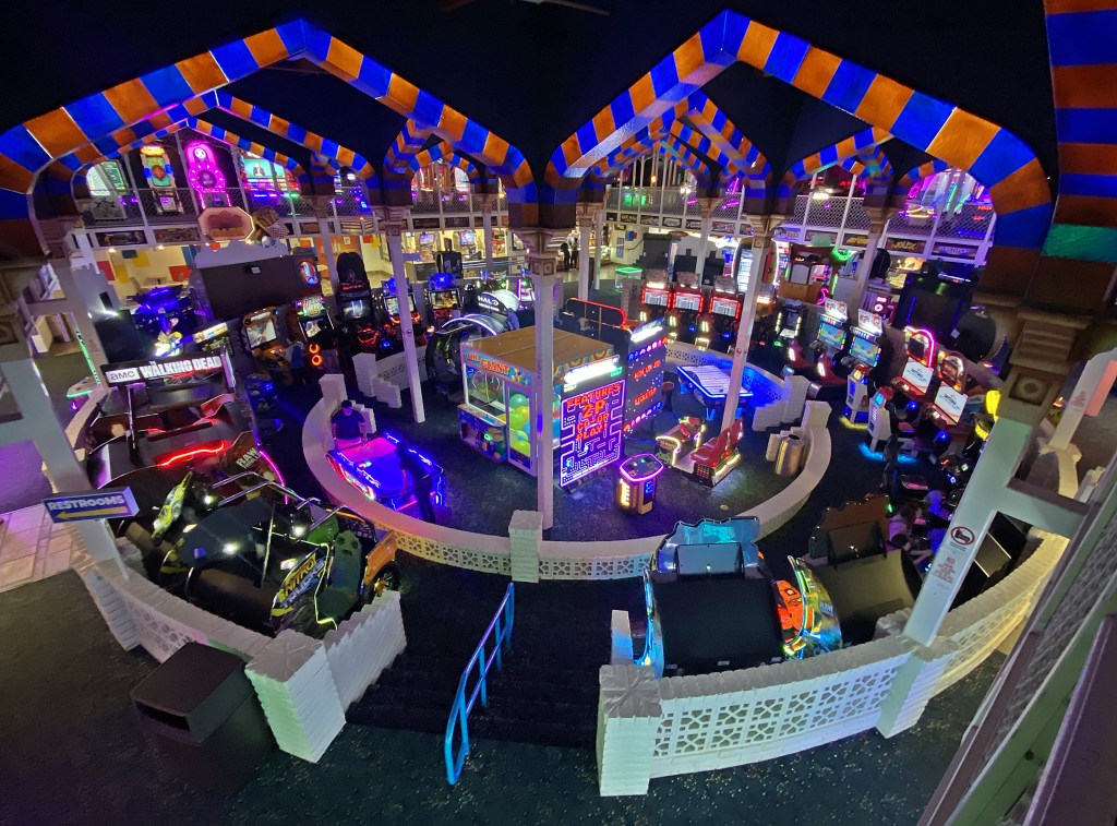 Wide view of the two-story arcade inside Castles N’ Coasters in Phoenix, filled with modern games.