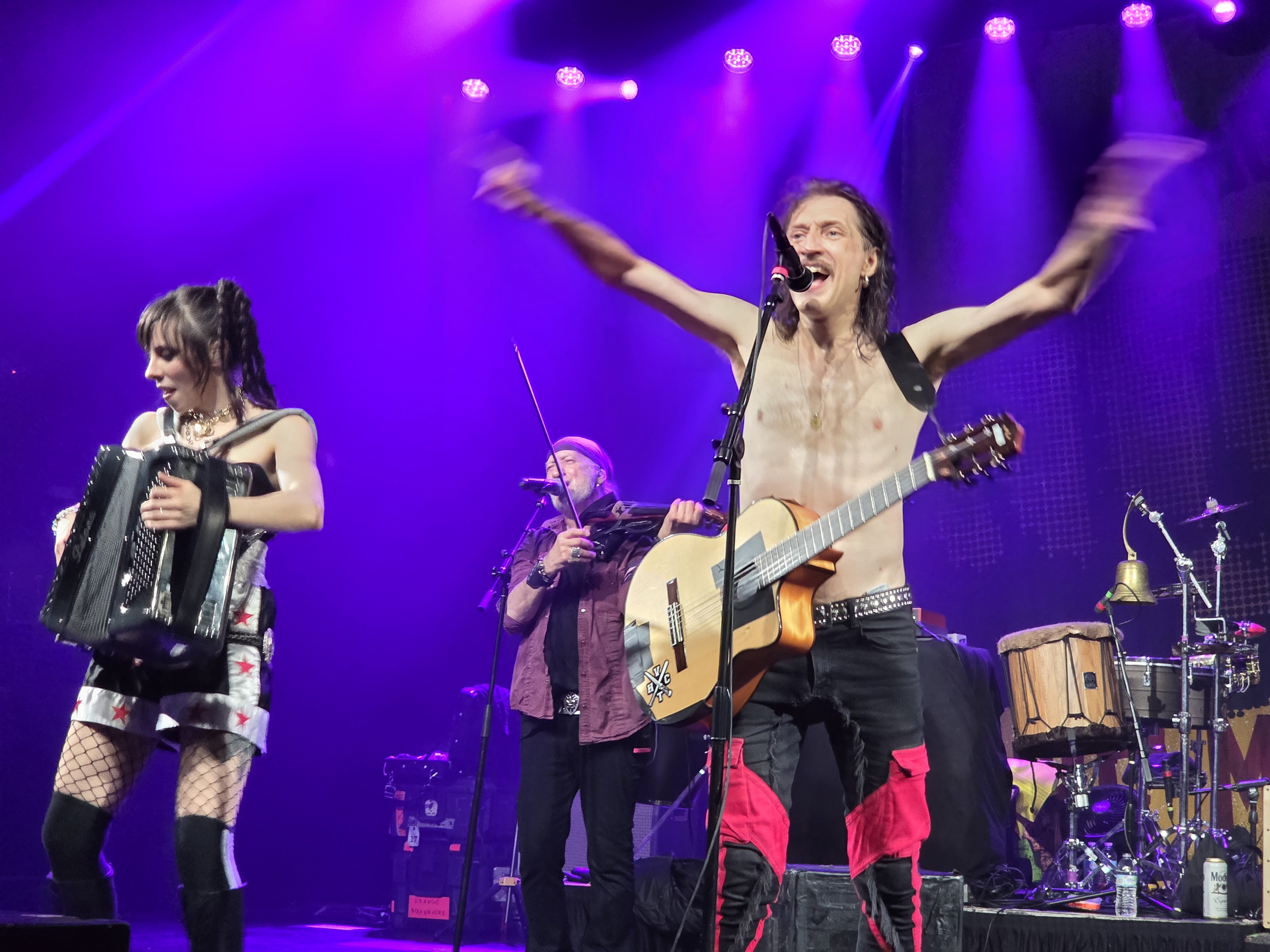 Erica Mancini, Sergey Ryabtsev and Eugene Hütz play during a Gogol Bordello set