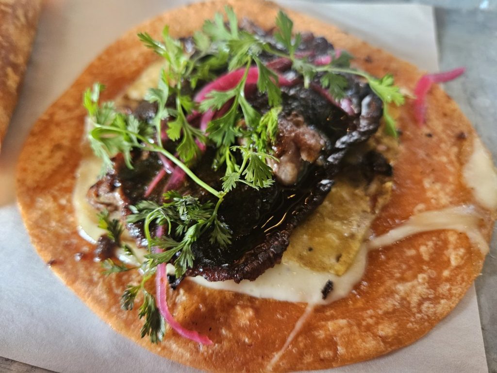 A close up image of a costra taco with ribeye.