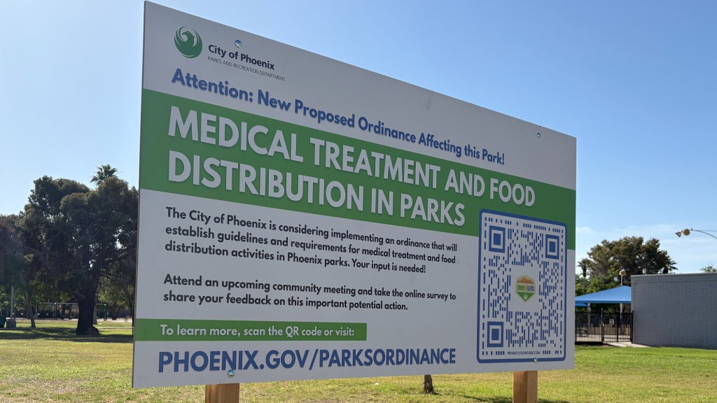 a sign in hermoso park warning about a proposed city ordinance that would limit the distribution of food and medical care in the park