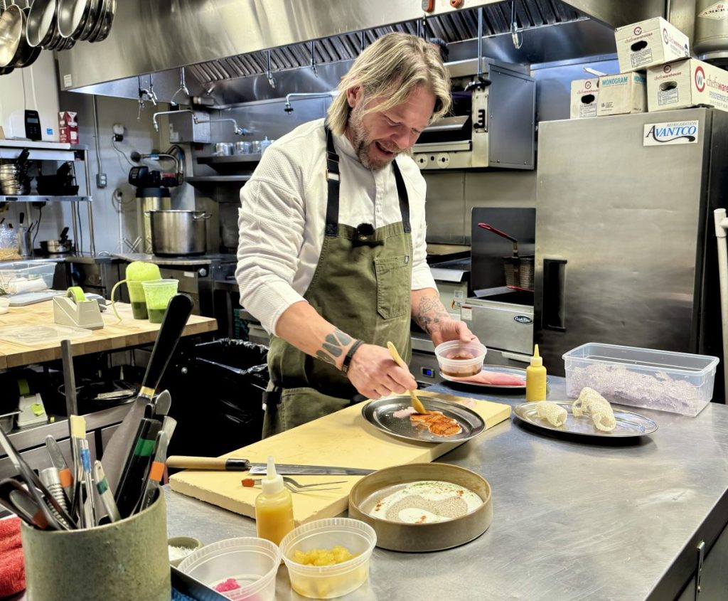 Chef Steven "Chops" Smith brushes slices of hamachi with an al pastor-style glaze.