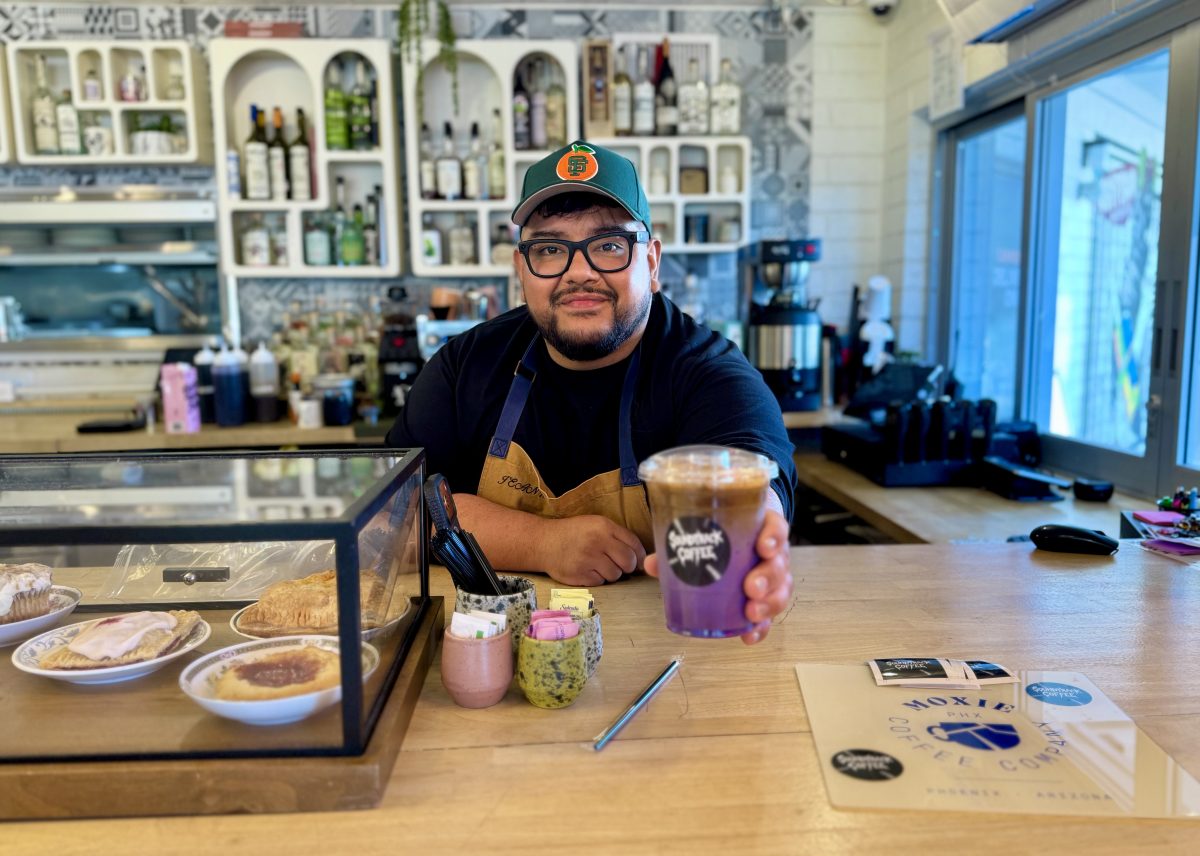 Soundtrack Coffee owner Joe Ramirez hands an ube latte across the bar at Chilte.